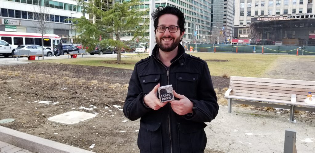 20190213_120535 LOVE Park manager Andrew Emma holds new granite block for sale (Tom MacDonald/WHYY)