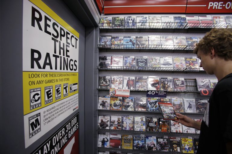Jack Schooner, 16, looks at Grand Theft Auto video game at GameStop in Palo Alto, Calif., Monday, June 27, 2011. The Supreme Court ruled Monday that it is unconstitutional to bar children from buying or renting violent video games, saying government doesn't have the authority to 