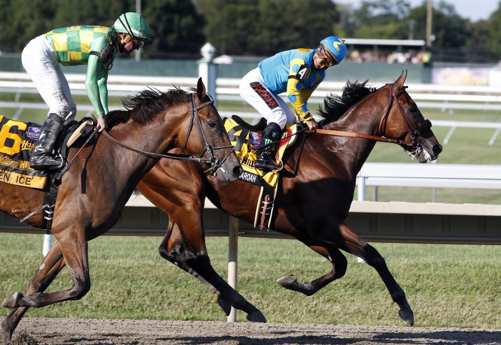 In this Sunday, Aug. 2, 2015 file photograph, jockey Victor Espinoza, (right), on Triple Crown winner American Pharoah(4), looks back at jockey Kent Desormeaux on Keen Ice (6) after American Pharoah won the Haskell Invitational horse race at Monmouth Park in Oceanport, N.J. (Mel Evans/AP Photo, File)