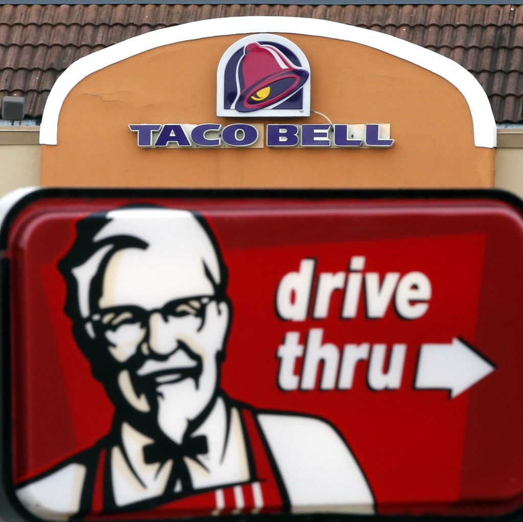 Earns Yum Brands This Jan. 31, 2014, file photo, shows a Taco Bell facade behind a KFC drive-thru sign (Elise Amendola/AP Photo, File)