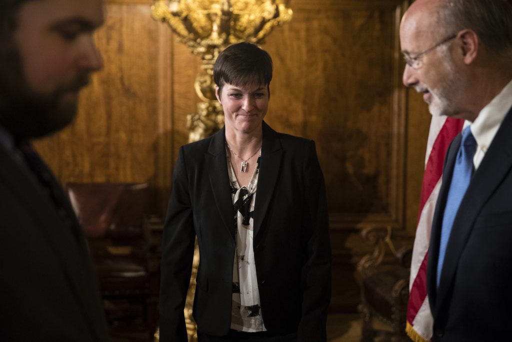 Wolf Consolidating Agencies Teresa Miller, center, accompanied by Gov. Tom Wolf, right, depart a news conference at the Pennsylvania Capitol in Harrisburg, Pa., Tuesday, May 23, 2017. (Matt Rourke/AP Photo)