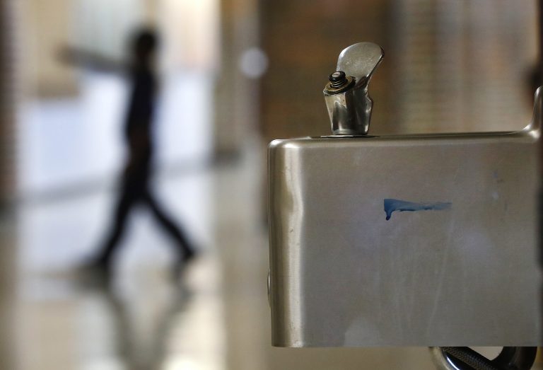 A student walks in the hallway past a water fountain at Noble School in Detroit, Tuesday, Sept. 4, 2018. (Paul Sancya/AP Photo)