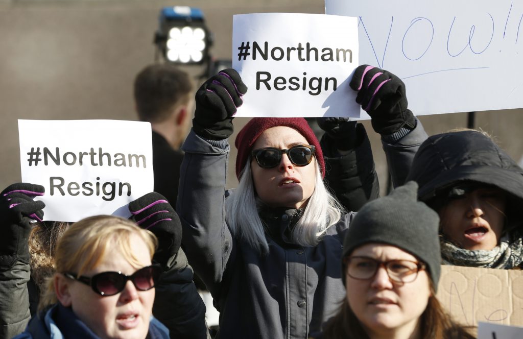 Governor Klan Blackface Demonstrators hold signs and chant outside the Governors Mansion at the Capitol in Richmond, Virginia, Saturday, calling for Gov. Ralph Northam to resign. (AP Photo/Steve Helber)
