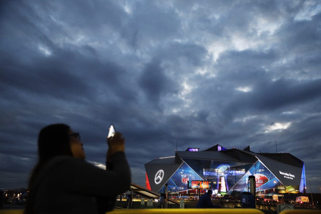 Patriots Rams Super Bowl Football Mercedes-Benz Stadium is lit up ahead of Sunday's NFL Super Bowl 53 football game between the Los Angeles Rams and New England Patriots in Atlanta, Saturday, Feb. 2, 2019. (AP Photo/David Goldman)