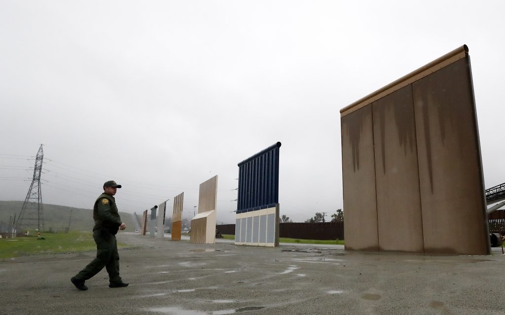 State of the Union Border Wall Border Patrol agent Vincent Pirro walks towards prototypes for a border wall Tuesday, Feb. 5, 2019, in San Diego. President Donald Trump is expected to speak about funding for a wall along the U.S.-Mexico border during his State of the Union address Tuesday. (Gregory Bull/AP Photo)