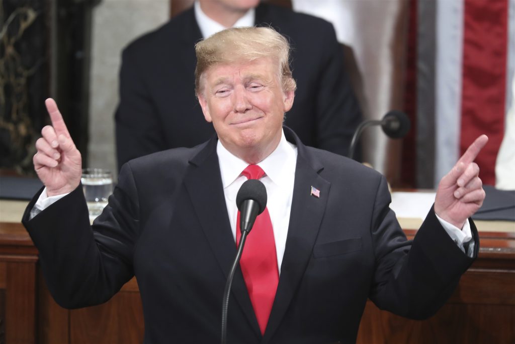 Donald Trump President Donald Trump gestures as a conductor as people in the chamber sing