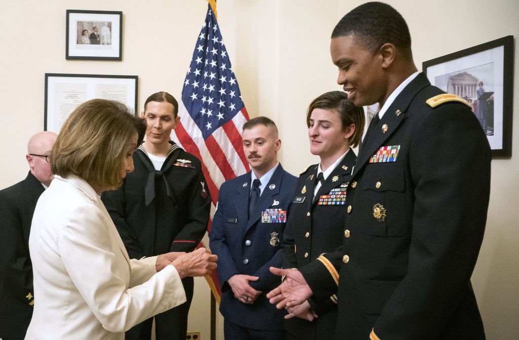 Nancy Pelosi, Ian Brown In this Tuesday, Feb. 5, 2019 photo released by her office, Speaker of the House Nancy Pelosi, D-Calif., left, gives challenge coins to U.S. Army Maj. Ian Brown, right, and other military service members to thank them for their service, in her office at the Capitol following the State of the Union address in Washington. Brown, 38, is a two-time Bronze Star recipient who transitioned from female to male while advising the Army's deputy chief of staff in operations and planning. (Julio Obscura/Office of the Speaker of the House Nancy Pelosi via AP)