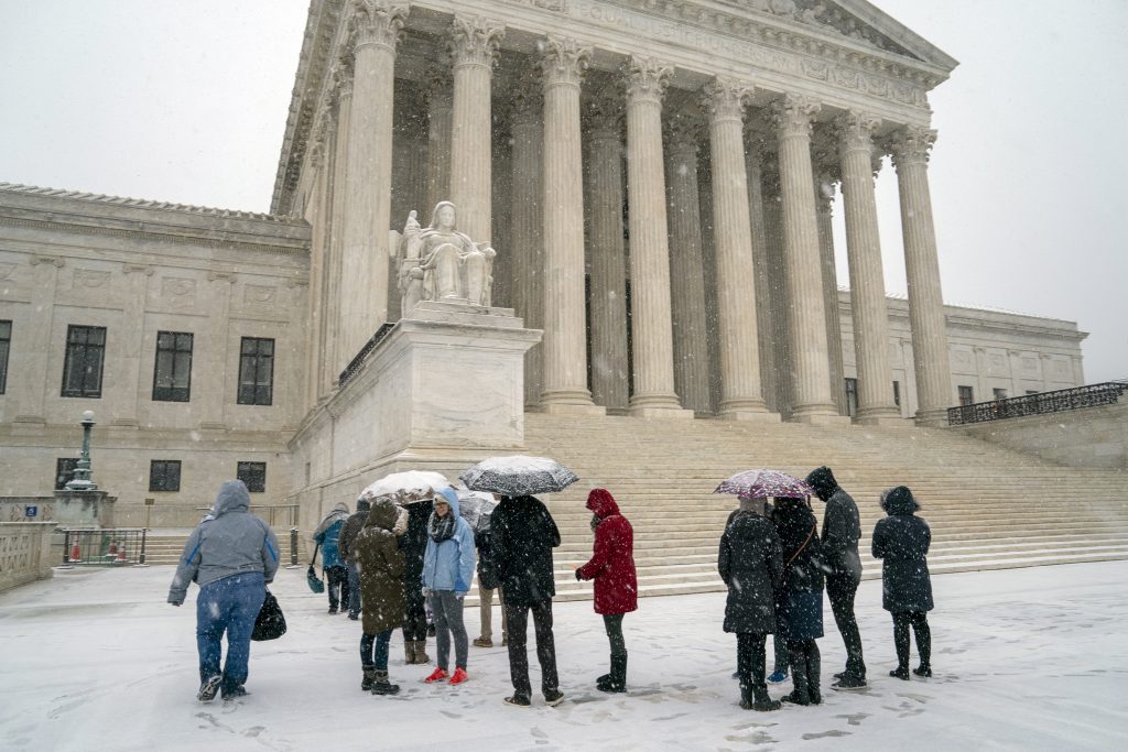 Supreme Court Excessive Fines Visitors wait to enter the Supreme Court as a winter snow storm hits the nation's capital making roads perilous and closing most Federal offices and all major public school districts, on Capitol Hill in Washington, Wednesday, Feb. 20, 2019. The Supreme Court is ruling unanimously that the Constitution's ban on excessive fines applies to the states. (J. Scott Applewhite/AP Photo)