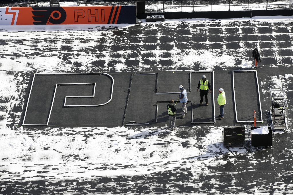 Ice Evolution Workers continue preparations ahead of the NHL Winter Classic hockey game between the Pittsburgh Penguins and Philadelphia Flyers, in Philadelphia, Thursday, Feb. 21, 2019. (Matt Rourke/AP Photo)