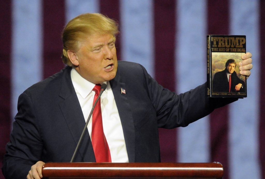 Donald Trump In this file photo, then-Republican presidential candidate Donald Trump holds up his book 'The Art of the Deal', given to him by a fan as he speaks during a campaign stop Saturday, Nov. 21, 2015 in Birmingham, Ala. (Eric Schultz/AP Photo)