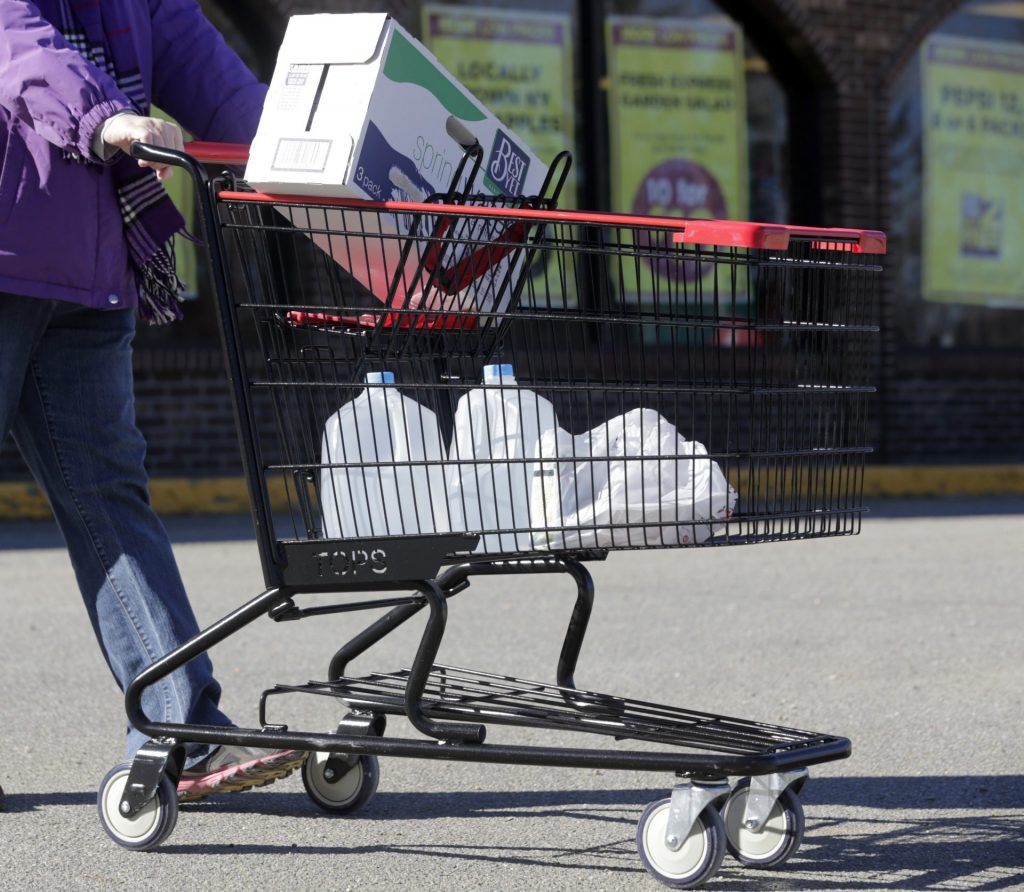 PFAS-water-contamination-1920×1672 In this Friday, Feb. 26, 2016 photo, a woman leaves a Tops supermarket with bottled water that is being supplied to residents in Hoosick Falls, N.Y. PFOA, long used in the manufacuring of Teflon pans, Gore-Tex jackets, ski wax, and many other products has turned up in the water in factory towns around the country like Hoosick Falls, impacting drinking water. (AP Photo/Mike Groll)