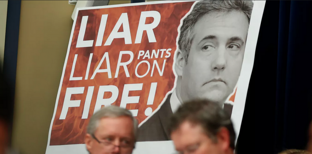 Screen Shot 2019-02-28 at 2.13.14 PM A sign behind Republican members of the committee during Michael Cohen’s testimony before a House Committee Wednesday. (Carlos Barria/Reuters)