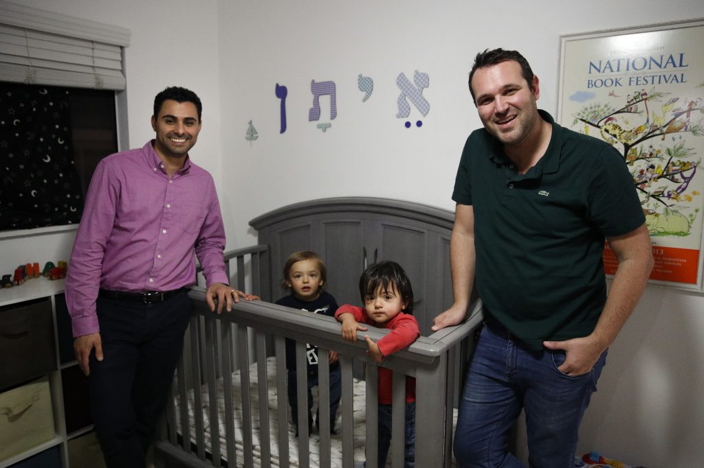 Elad Dvash-Banks (left) and his husband, Andrew, pose for photos with their twin sons, Ethan (center right), and Aiden in their apartment last year in Los Angeles. Elad Dvash-Banks (left) and his husband, Andrew, pose for photos with their twin sons, Ethan (center right), and Aiden in their apartment last year in Los Angeles. (Jae C. Hong/AP)