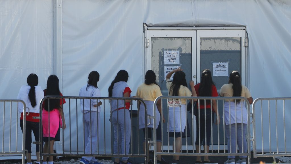 Children line up to enter a tent at the Homestead Temporary Shelter for Unaccompanied Children. Once youth turn 18, they are aged out of the children’s shelter and are at risk of being placed in an adult detention facility. Children line up to enter a tent at the Homestead Temporary Shelter for Unaccompanied Children. Once youth turn 18, they are aged out of the children's shelter and are at risk of being placed in an adult detention facility.
(Wilfredo Lee/AP)