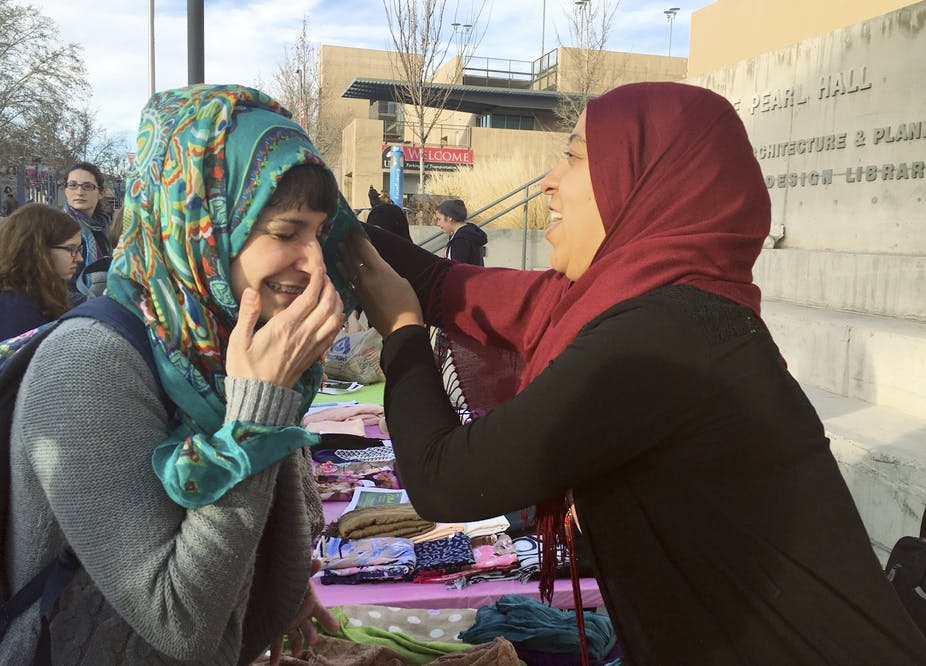 file-20190131-112314-ixemi4 A student on the campus of the University of New Mexico in Albuquerque, trying out the hijab on World Hijab Day, 2017. (Russell Contreras/AP Photo)