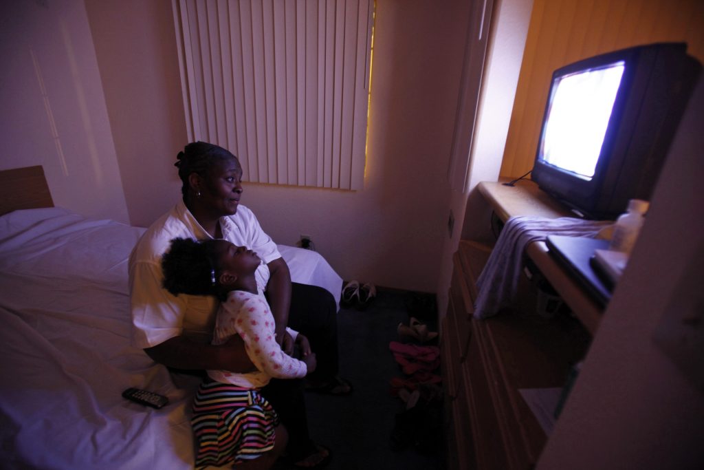 Wilson watches television with her daughter, Woods in the motel room where the family is living in Grand Prairie Black Americans were most affected by the 2009 recession. (Jessica Rinaldi/Reuters)