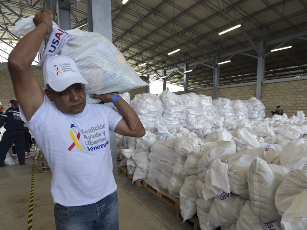 A volunteer carries a bag with U.S. humanitarian aid goods in Cúcuta, Colombia, along the border with Venezuela, on Feb. 8. A volunteer carries a bag with U.S. humanitarian aid goods in Cúcuta, Colombia, along the border with Venezuela, on Feb. 8. (Raul Arboleda/AFP/Getty Images)