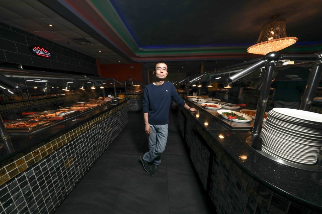032819-Restaurant owner Guang Chen-SS Guang Chen, who also owns Hibachi Grill & Supreme Buffet in Glasgow, is planning to open a restaurant near Newark where robots will seat and serve patrons. (Saquan Stimpson for WHYY)