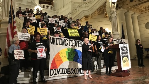 In this file photo, Pat Albright speaks at the state Capitol in defense of the General Assistance program, flanked by sign language translators. (Katie Meyer/WITF)