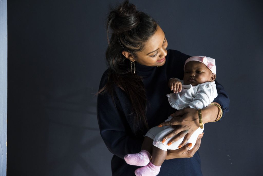 2019 02 09-r wisniewski-Asasiya Muhammad Winter Nimmons-philadelphia germantown-midwife Midwife Asasiya Muhammad poses for a portrait with two-month-old Winter Nimmons at her practice, Inner Circle Midwifery, on February 9. Muhammad delivered Nimmons two months ago and had to resuscitate Winter when she was born not breathing. (Rachel Wisniewski/WHYY)