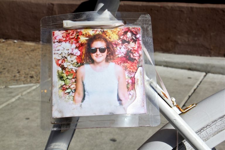 A ghost bike memorial to Laura Fredericks still stands at the intersection of 11th and Spruce streets, where she was struck and killed by a garbage truck while riding in the bike lane. (Emma Lee/WHYY)