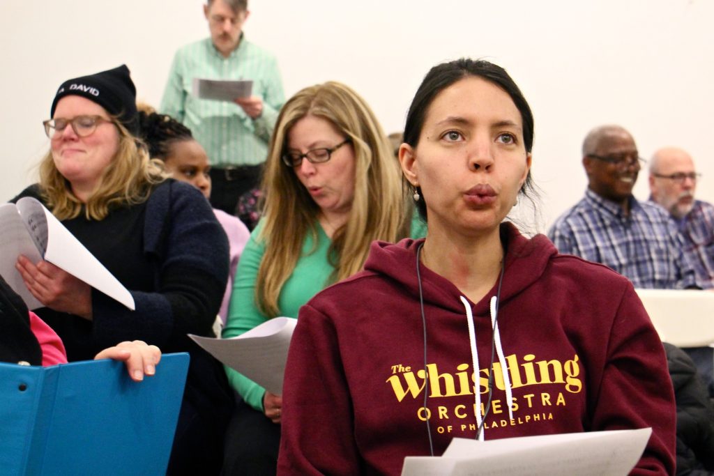 2019 03 12-e lee-bria blauvelt-philadelphia temple contemporary-whistling orchestra Bria Blauvelt rehearses with the newly formed Whistling Orchestra of Philadelphia. She traveled from her home in Egg Harbor Township for the opportunity to put her talent to work with a group. (Emma Lee/WHYY)