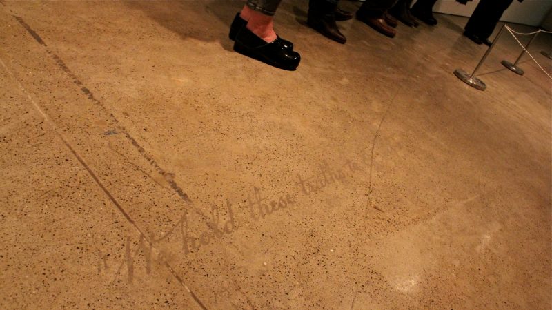 Words from the Declaration of Independence emerge from the dirty floor. In a public performance that will open the exhibit, artist Sonya Clark will clean the floor using a dishcloth commercially printed with the Confederate battle flag, revealing the text. (Emma Lee/WHYY)