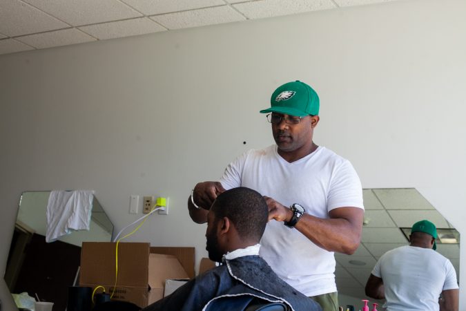 Darian McFadden, a local barber, provided haircuts to men at the 2019 Men's Health Iniative at Enon Tabernacle Baptist Church Saturday. (Brad Larrison for WHYY)