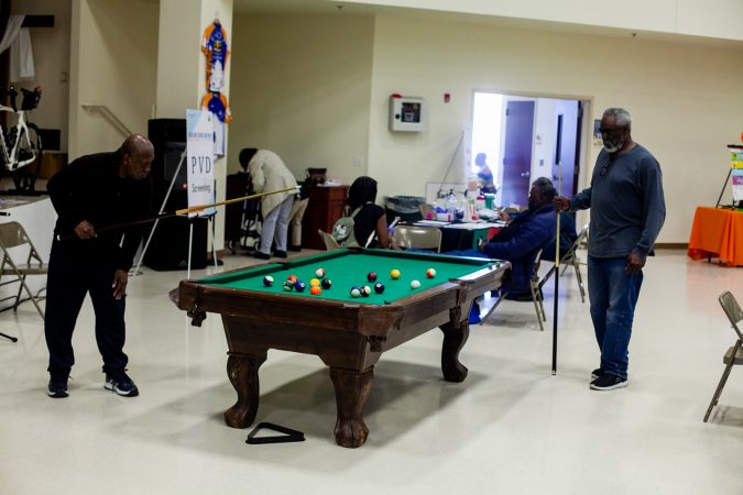 Daniel Brooks, (left), and Tyrone Hicks play a game of pool at the 2019 Men's Health Iniative at Enon Tabernacle Baptist Church Saturday. (Brad Larrison for WHYY)