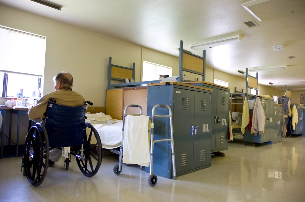 Aging Inmates In this photo taken Tuesday, Aug. 3, 2010, an inmate sits in is his wheelchair near his bed (Sandy Summers Russell/AP Photo)
