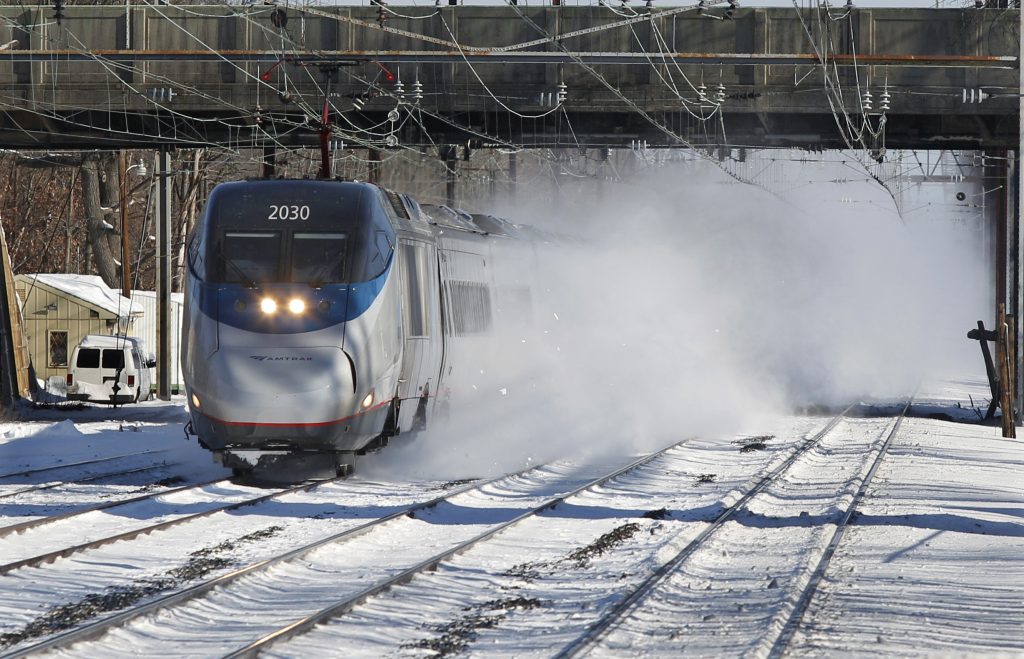 Winter Weather In this file photo, an Amtrak Acela train blows snow as it passes through the Princeton Junction station in West Windsor, N.J. (Mel Evans/AP Photo)