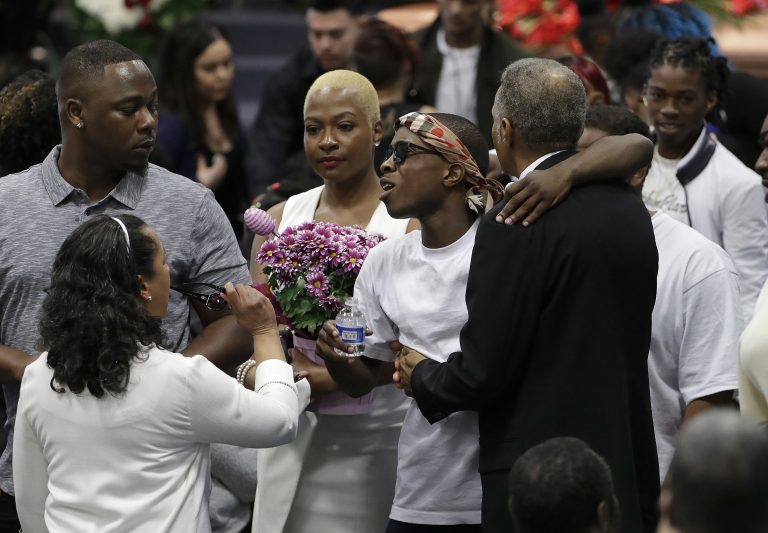 Stevante Clark, (center right), hugs family and mourners during the funeral services for police shooting victim Stephon Clark at Bayside Of South Sacramento Church in Sacramento, Calif., Thursday, March 29, 2018. Clark, who was unarmed, was shot and killed by Sacramento Police Officers, Sunday, March 18, 2018. (Jeff Chiu/AP Photo, Pool)
