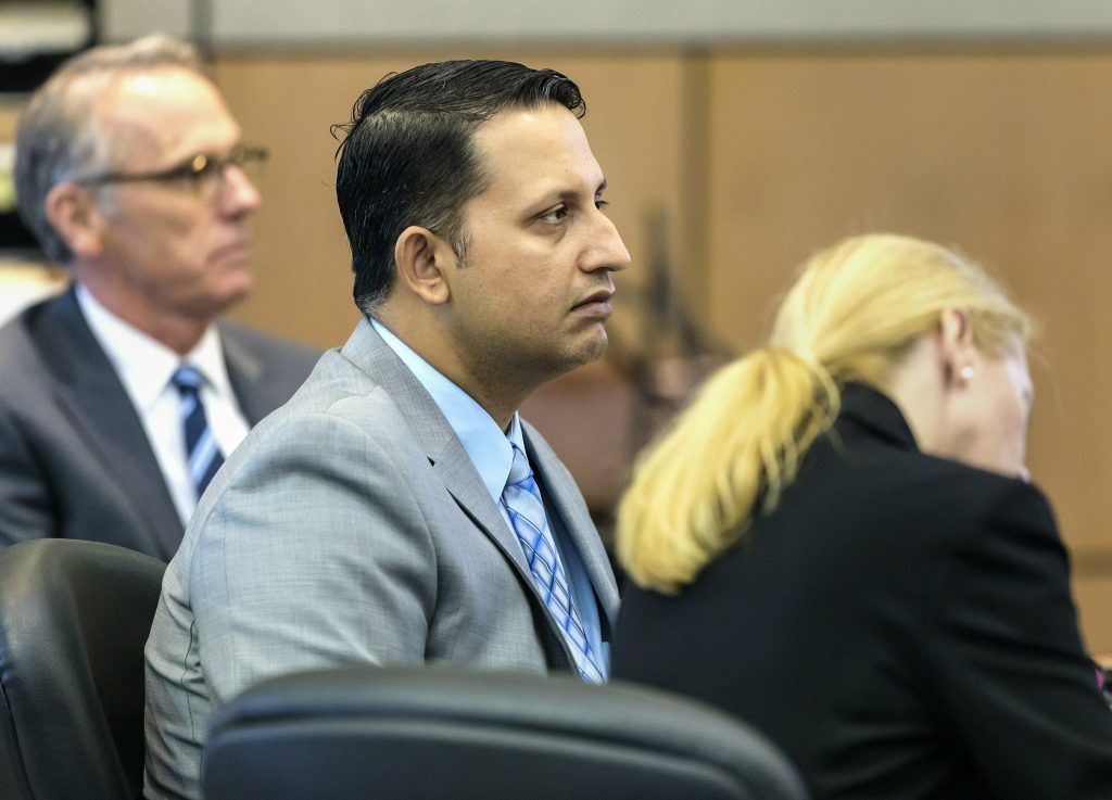 Police Shooting Florida-Stand Your Ground Nouman Raja sits between defense attorney Scott Richardson, (left), and paralegal Debi Stratton as attorney Richard Lubin gives his closing arguments in Raja's trial, Wednesday, March 6, 2019 in West Palm Beach, Fla. (Lannis Waters/Palm Beach Post via AP, Pool)