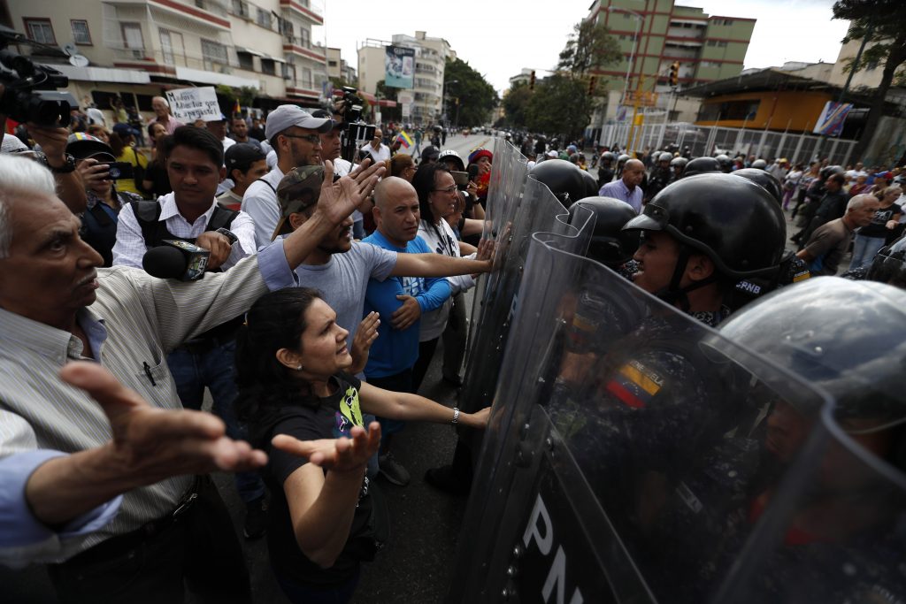 Venezuela Political Crisis Venezuelan police block a crowd of people who gather to march against the government of President Nicolas Maduro, in Caracas, Venezuela, Saturday, March 9, 2019. Security forces are deploying in large numbers in Caracas ahead of the planned demonstrations by supporters of opposition leader Juan Guaido. (Eduardo Verdugo/AP Photo)