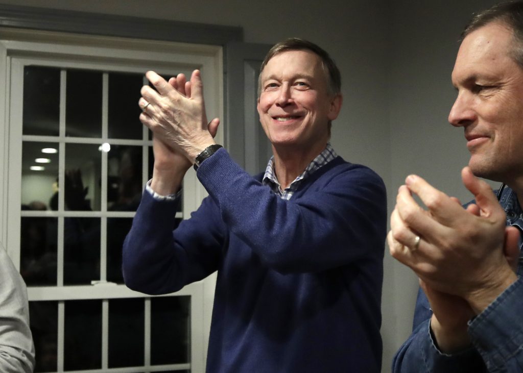 John Hickenlooper FILE - In this Feb. 13, 2019, file photo, former Colorado Gov. John Hickenlooper, left, applauds at a campaign house party in Manchester, N.H. While the Democratic primary field has shifted left, polls show registered Democratic voters just want someone who can beat Donald Trump. That’s led to a potential contradiction being worked over by primary voters. Is the best route to victory to build a liberal movement to win converts or choose a more moderate candidate who can appeal to swing voters? (Elise Amendola/AP Photo, File)