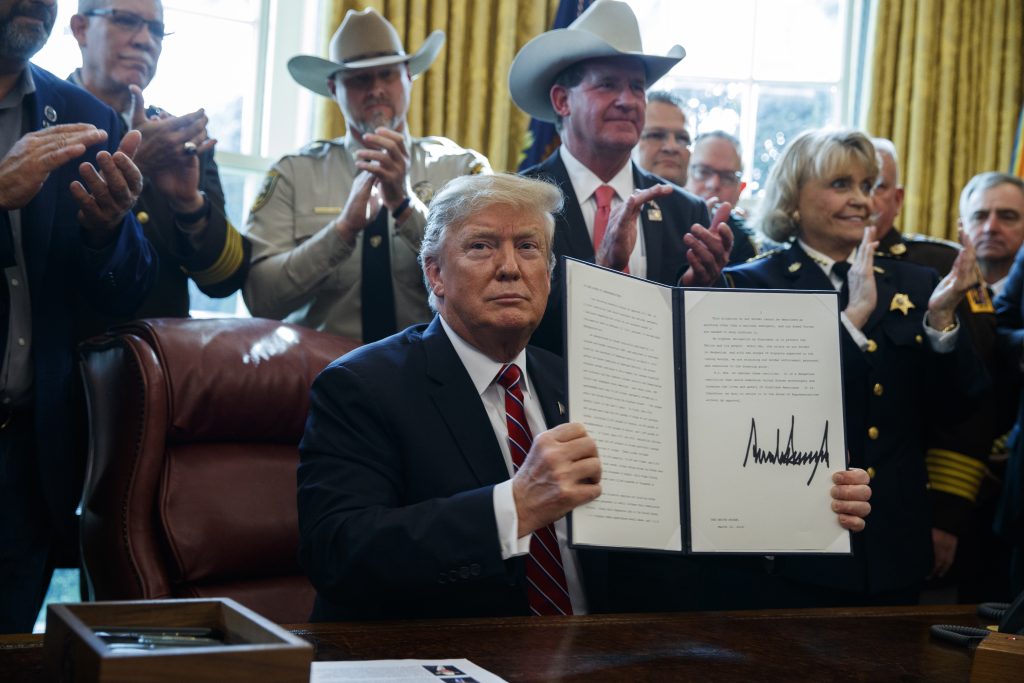 President Donald Trump signs the first veto of his presidency in the Oval Office of the White House, Friday, March 15, 2019, in Washington. (Evan Vucci/AP Photo)