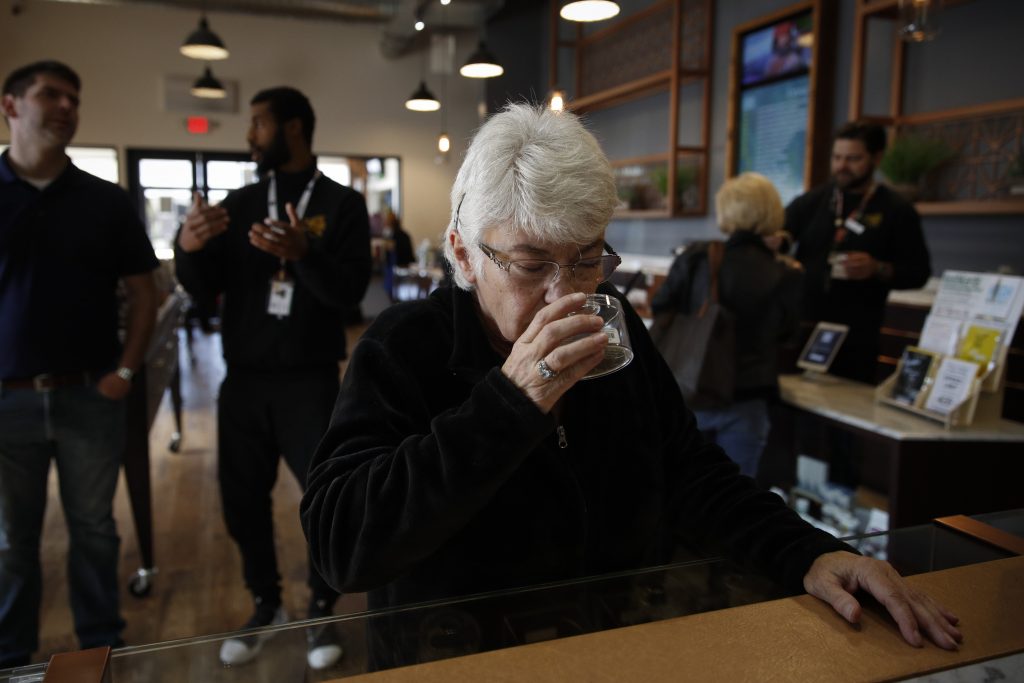 Marijuana Seniors In this Feb. 19, 2019 photo, Sandy Sopher, 65, smells cannabis buds at Bud and Bloom cannabis dispensary in Santa Ana, Calif. As legal cannabis has spread to dozens of states, more Americans in their 70s and 80s are adding marijuana to the roster of senior activities such as golf and bingo. (AP Photo/Jae C. Hong)