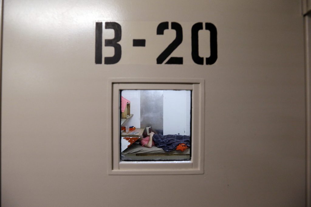 Mentally Ill Contempt Orders In this Oct. 15, 2014 file photo, an inmate lies on a bunk reading in the psychiatric unit of the Pierce County Jail in Tacoma, Washington. In Pennsylvania, some inmates deemed mentally unfit for trial are housed in similar facilities for up to five months before being put in treatment. (Elaine Thompson/AP Photo)