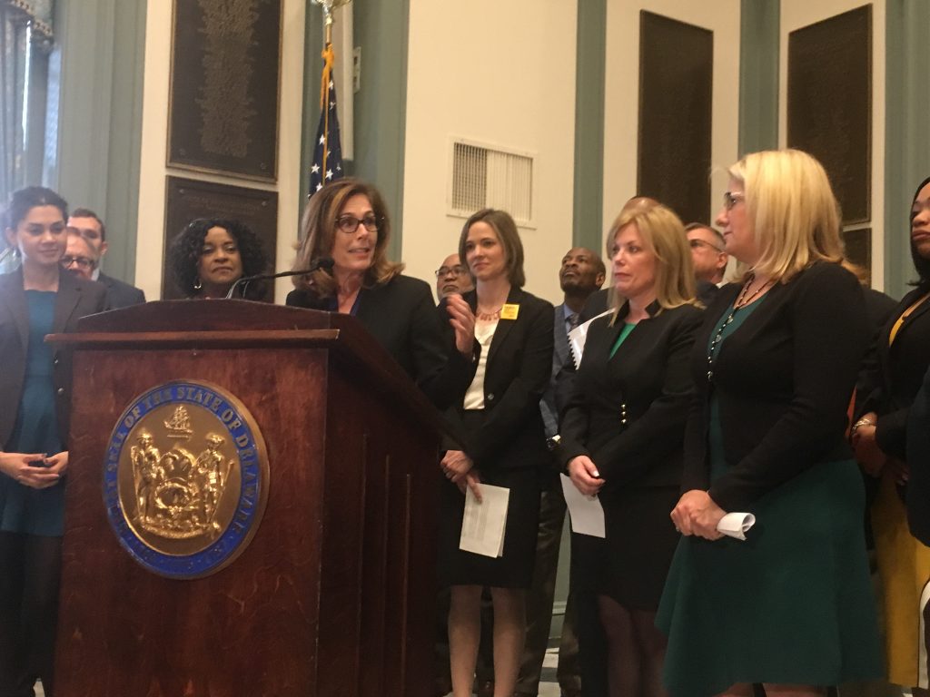 IMG_3305 Delaware Attorney General Kathy Jennings unveils a package of criminal justice reform bills surrounded by state lawmakers in Legislative Hall in Dover. (Mark Eichmann/WHYY)