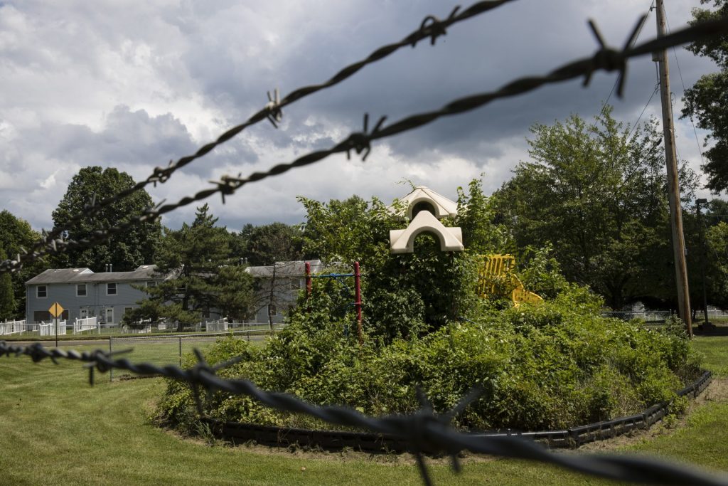 In this Aug. 1, 2018 photo weeds engulf a playground at housing section of the former Naval Air Warfare Center Warminster in Warminster, Pa. In Warminster and surrounding towns in eastern Pennsylvania, and at other sites around the United States, the foams once used routinely in firefighting training at military bases contained per-and polyfluoroalkyl substances, or PFAS. (Matt Rourke/AP Photo)