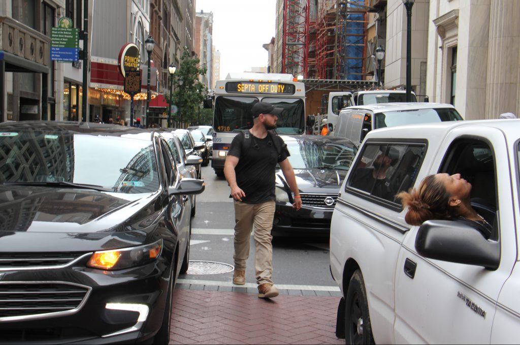 a-pedestrian-threads-his-way-through-snarled-traffic-at-broad-and-chestnut-streets-emma-lee-whyy.original A pedestrian threads his way through snarled traffic at Broad and Chestnut streets. (Emma Lee/WHYY)
