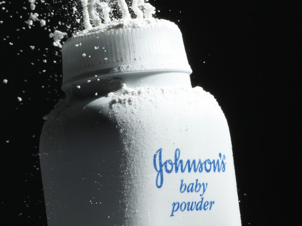 In this file photo, Johnson’s baby powder is squeezed from its container. Johnson & Johnson baby powder