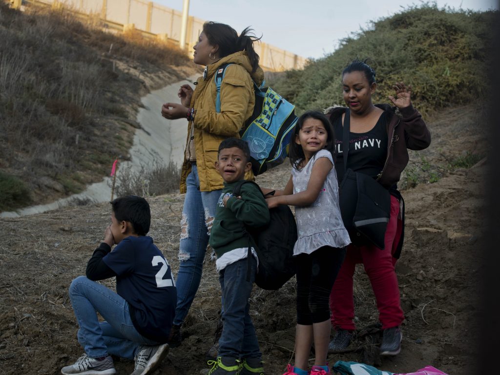 Honduran migrants react as they surrender to the U.S. Border Patrol after crossing the border wall into the United States. According to new federal data, the number of migrants apprehended crossing the border in recent months has surged. Honduran migrants react as they surrender to the U.S. Border Patrol after crossing the border wall into the United States. According to new federal data, the number of migrants apprehended crossing the border in recent months has surged.
(Ramon Espinosa/AP)