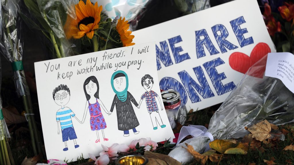 A message card is placed at a collection of flowers left at the Botanical Gardens in Christchurch, New Zealand, on Saturday. A 28-year-old white supremacist stood silently before a judge, accused in mass shootings at two mosques that left dozens of people dead. A message card is placed at a collection of flowers left at the Botanical Gardens in Christchurch, New Zealand, on Saturday. A 28-year-old white supremacist stood silently before a judge, accused in mass shootings at two mosques that left dozens of people dead. (Vincent Thian/AP Photo)