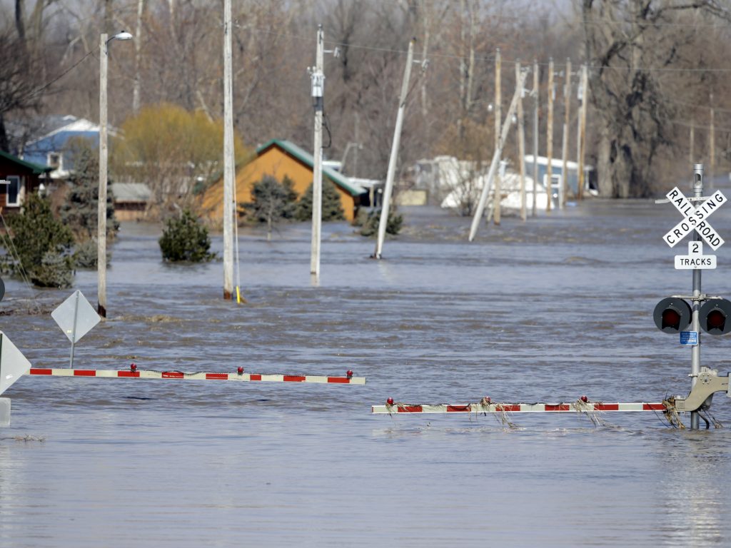 A railroad crossing is flooded with water from the Platte River in Plattsmouth, Neb. Record high floodwaters inundated regions of the Midwest following an intense winter storm and rapid snowmelt. A railroad crossing is flooded with water from the Platte River in Plattsmouth, Neb. Record high floodwaters inundated regions of the Midwest following an intense winter storm and rapid snowmelt.
(Nati Harnik/AP Photo)