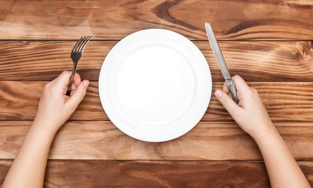 Hungry Child Waiting For Meal. Child’s Hands Holding Fork And Kn Hungry Child Waiting For Meal. Child's Hands Holding Fork And Kn