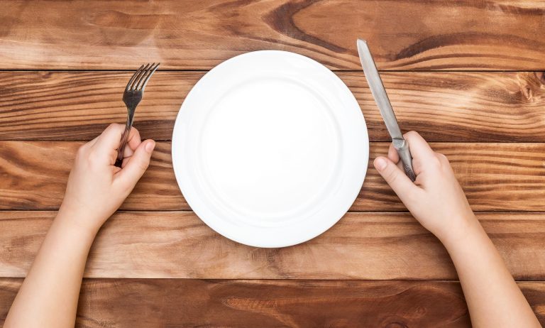 Hungry Child Waiting For Meal. Child's Hands Holding Fork And Kn