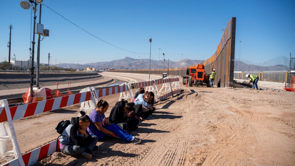 Salvadoran migrants wait for transportation after turning themselves in to U.S. Border Patrol agents in El Paso, Texas — where a border fence is under construction. The Pentagon says it will spend up to $1 billion to help build the fence. Salvadoran migrants wait for transportation after turning themselves in to U.S. Border Patrol agents in El Paso, Texas — where a border fence is under construction. The Pentagon says it will spend up to $1 billion to help build the fence. (Paul Ratje /AFP/Getty Images)