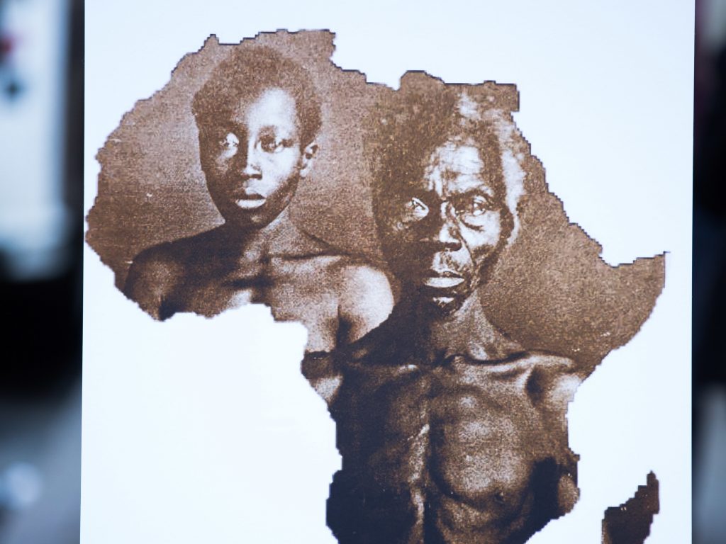A sample image of “Papa” Renty and his daughter Delia, taken in 1850, are displayed during a press conference announcing a lawsuit against Harvard University on Wednesday in New York City. A sample image of
