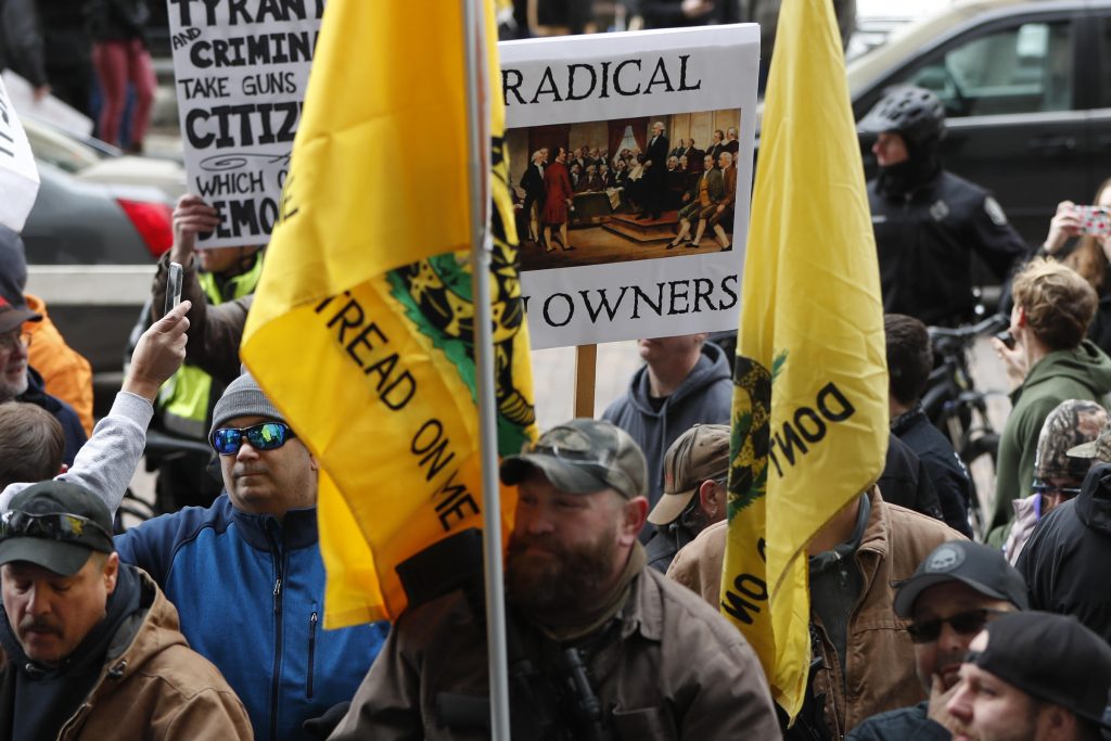Gun Ban Bill Armed Protest Protestors carry signs as they attend a rally on Monday, Jan. 7, 2019, in Pittsburgh. The protesters, many openly carrying guns, gathered in downtown Pittsburgh to rally against the city council's proposed restrictions and banning of semi-automatic rifles, certain ammunition and firearms accessories within city limits. (Keith Srakocic/AP Photo)
